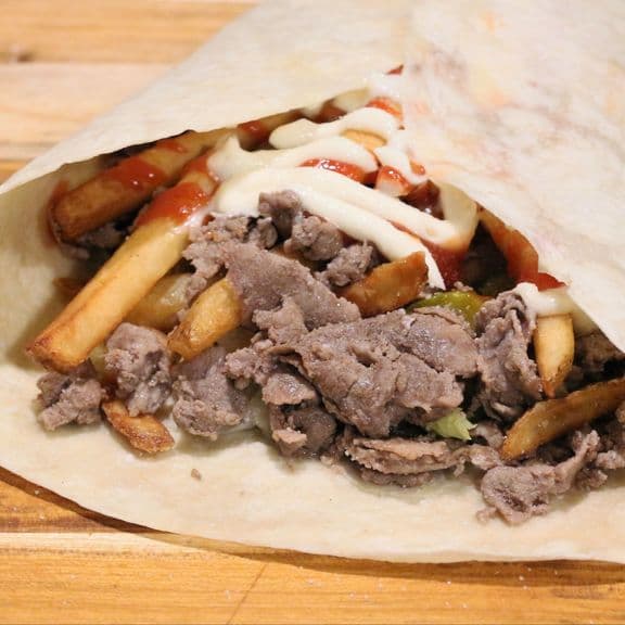 Upstate Wrap - Thin sliced steak, fresh lettuce, tomato, pickles, crispy french fries, American cheese, ketchup and mayo, wrapped in a warm tortilla.