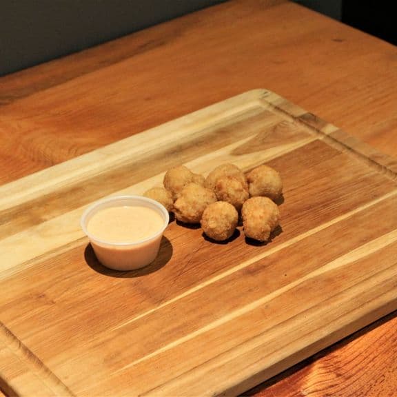 Breaded Mushroom Bites - Ten whole mushroom caps in a seasoned breading, crispy on the outside and tender on the inside. Prepared with our special blend of herbs and spices, paired with creamy garlic aioli.