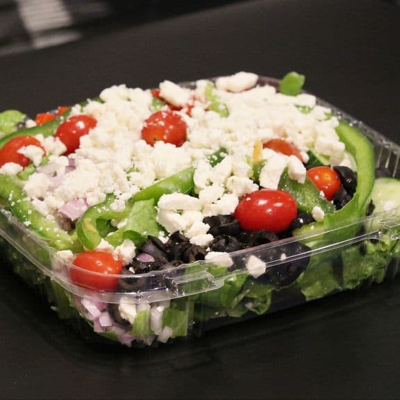 Mediterranean Salad - Fresh lettuce topped with crumbled feta cheese, crisp red and green peppers, red onions, cucumbers, sweet grape tomatoes and Kalamata olives. Served with our Greek vinaigrette.