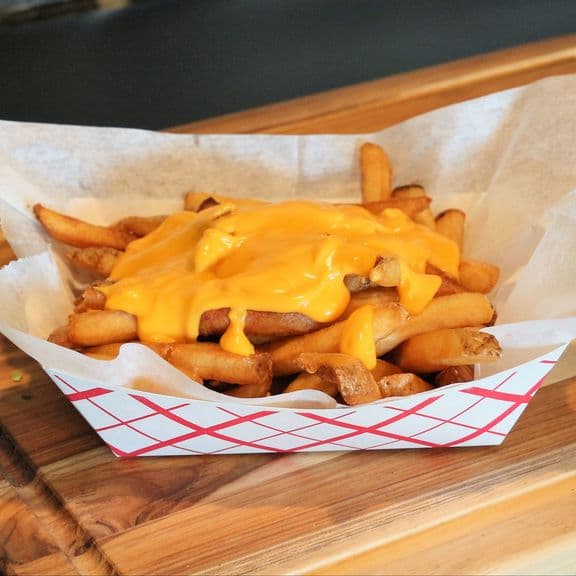 Cheesy Fries - French fries topped with melted cheddar cheese, creating a delicious combination of crispy fries and gooey cheese.