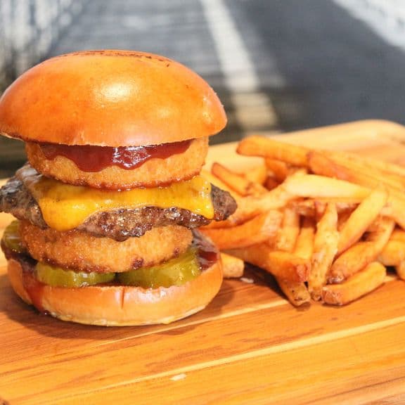 Bethlehem Burger - Fresh and natural, hand-crafted ground beef patty, onion rings, pickles, cheddar cheese, and BBQ sauce.
